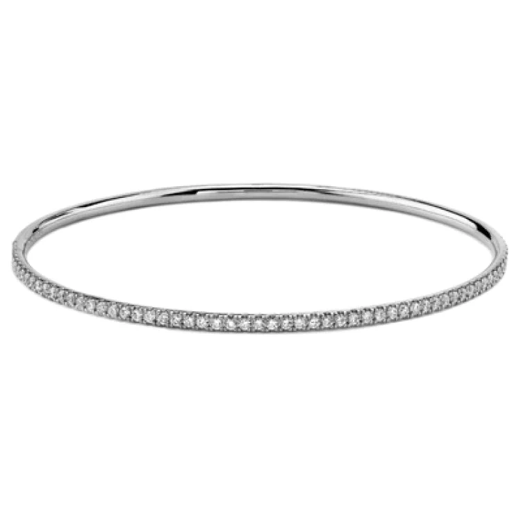 bracelets and bangles for beach wear -Simple but elegant, this classically styled white gold bangle bracelet is accentuated with .86 ctw of shimmering round white diamonds. Perfect for stacking.