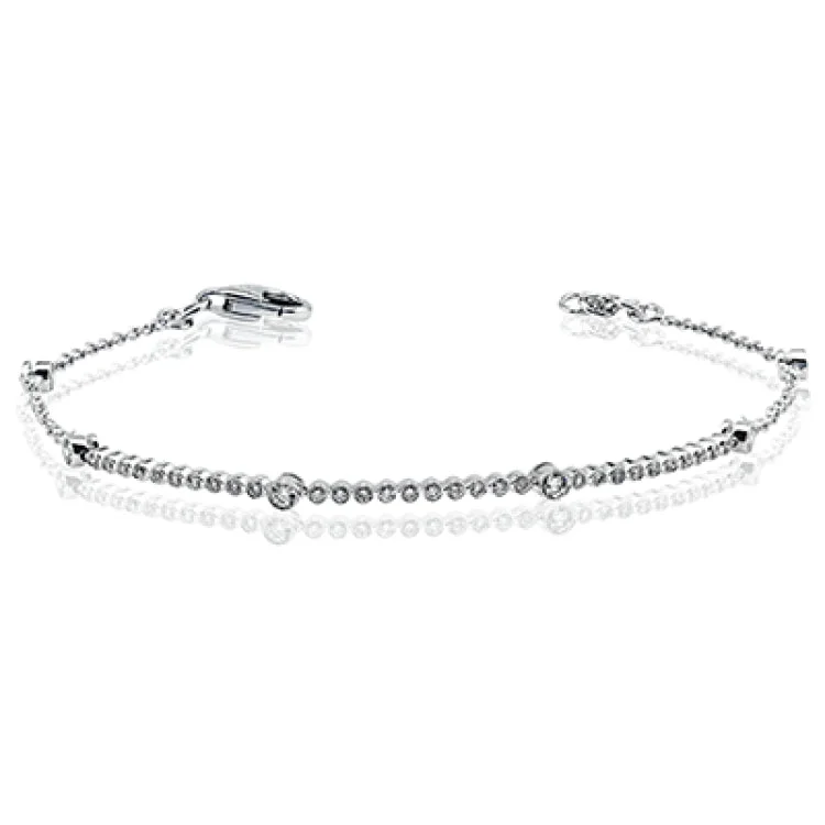 bracelets and bangles layered look -A delicate bracelet of bezel set diamonds 0.54 ctw. in 18K white gold, is a great layering piece